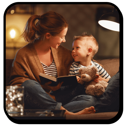  Mother and son cozy on the couch reading a book 