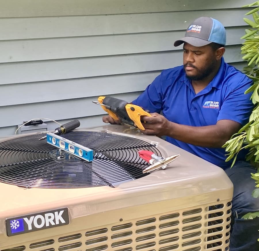 Blue Bear Plumbing, Heating, and Air employee performing an HVAC tune-up