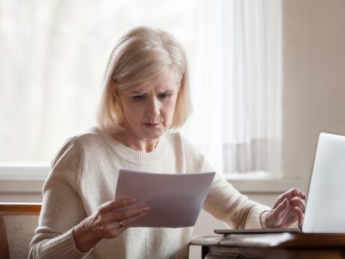 Older woman reading a bill