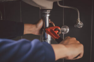 Plumber Fixing Kitchen Sink