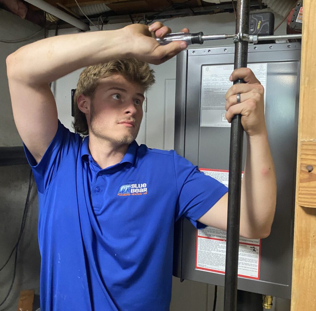 Blue Bear technician working on piping in a