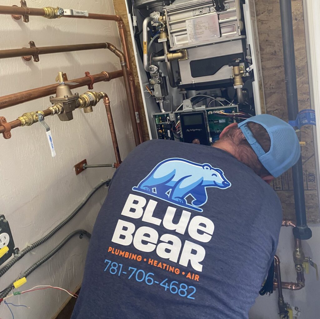 Blue Bear technician performing a repair service on a gas furnace in Lexington, MA