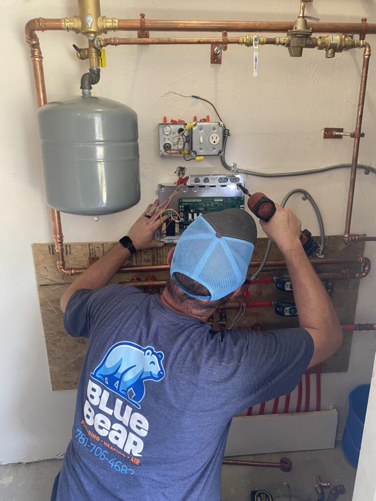 Blue Bear technician working on gas lines in a Norfolk, MA, home